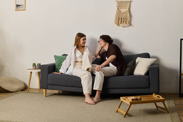 A young couple enjoys quality time together in their stylish apartment, filled with joy and warmth.