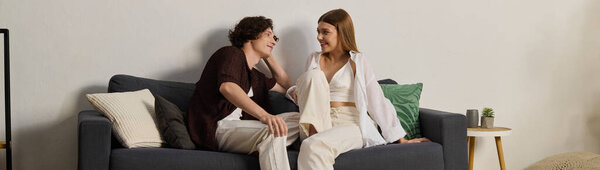 Curly-haired man and beautiful woman share joyful moments in their stylish apartment, banner