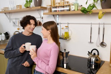 A loving couple shares a joyful moment in their modern kitchen, filled with warmth and love.