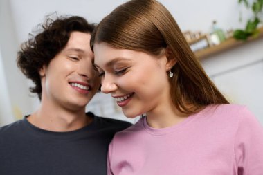 A happy couple makes beautiful memories in their modern apartment.