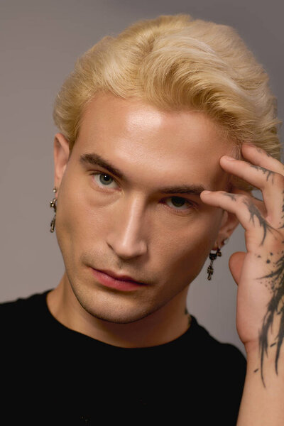 Красивый подросток позирует со стильным выражением лица, источая юношескую энергию и очарование.