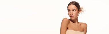 A young woman displays her natural makeup and glowing skin on a white background, banner