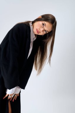 Young woman poses confidently in a trendy autumn outfit, highlighting her modern style.