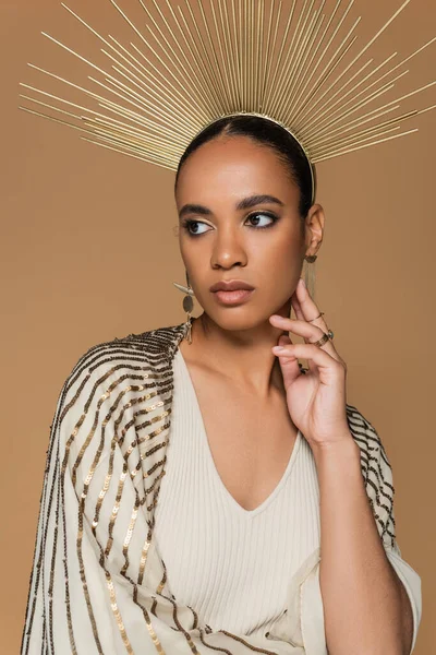 Brunette african american woman in shawl and golden crown posing isolated on beige — Stock Photo