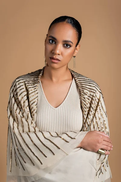 Pretty african american woman in shawl looking at camera isolated on beige — Stock Photo