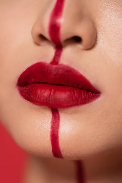 Close up view of cropped woman with red lips and vertical line on face — Stock Photo