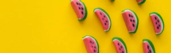 Top view of delicious candies in watermelon shape on yellow background, banner — Stock Photo