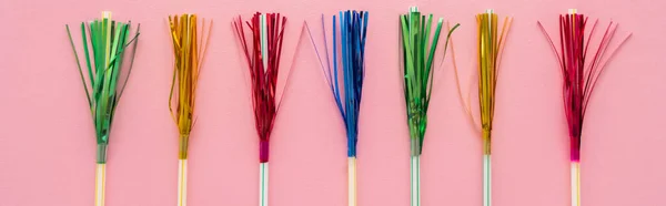 Top view of drinking straws with colorful tinsel on pink background, banner — Stock Photo