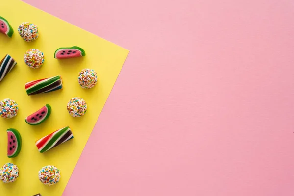 Vista superior de doces saborosos no fundo amarelo e rosa — Fotografia de Stock