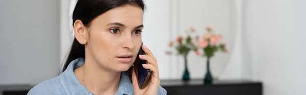 Brunette woman talking on smartphone at home, banner — Stock Photo