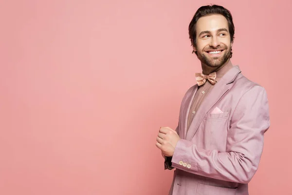 Positive host of event in jacket looking away isolated on pink with copy space — Stock Photo