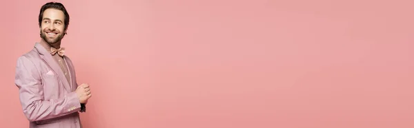 Trendy host of event looking away isolated on pink with copy space, banner — Stock Photo
