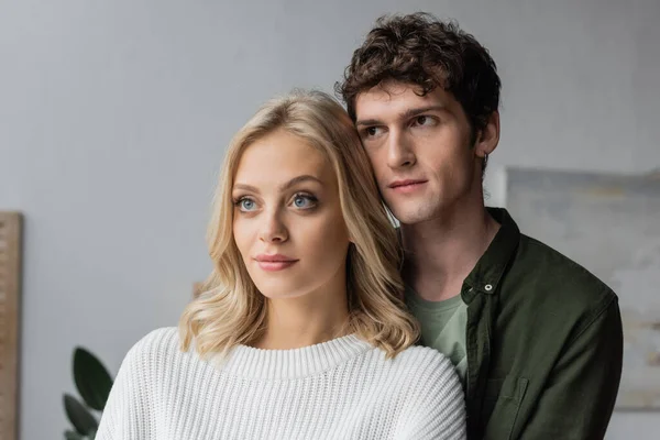 Portrait of curly young man and blonde woman in white sweater — Foto stock