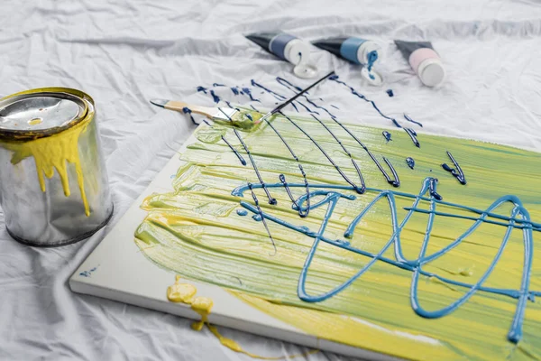 Paints on drawing on cloth in art studio — Stock Photo
