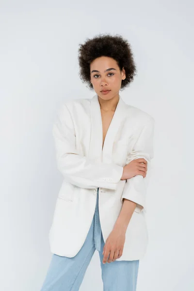 Stylish african american woman posing in jacket isolated on grey — Stock Photo