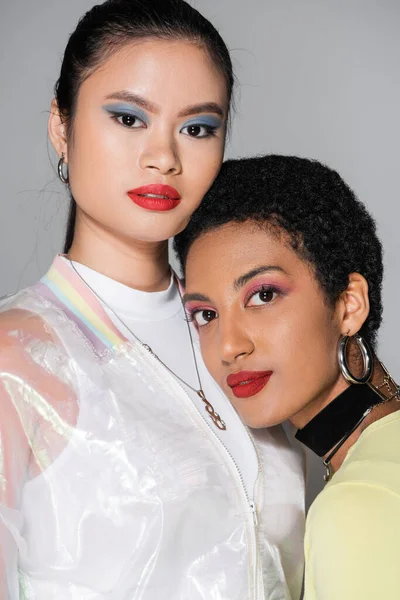 Portrait of stylish interracial models with red lips posing isolated on grey — Stock Photo