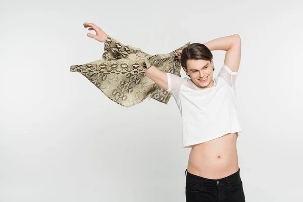 Carefree nonbinary person wearing snakeskin print blouse and looking away isolated on grey — Stock Photo