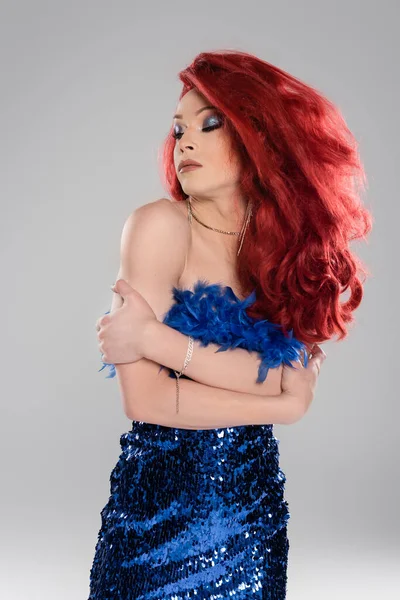 Drag queen en élégante robe bleue embrassant les bras isolés sur gris — Photo de stock