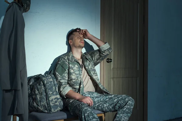 Military veteran with mental illness sitting in hallway at night — Stock Photo