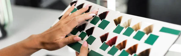 Cropped, hair professional, beauty worker holding hair color palette in beauty salon, hair extension, hair stylist, salon job, beauty salon work, hair trends, manicure, female hands, banner — Stock Photo