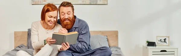 Quality time, happiness, reading book together, happiness, day off without kids, redhead husband and wife, bearded man and woman, relaxation, parents alone at home, lifestyle, adult leisure, banner — Stock Photo
