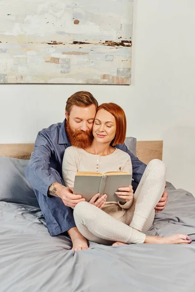 Quality time, reading book together, happiness, day off without kids, redhead husband and wife, happiness, bearded man and woman, relaxation, parents alone at home, lifestyle, adult leisure — Stock Photo