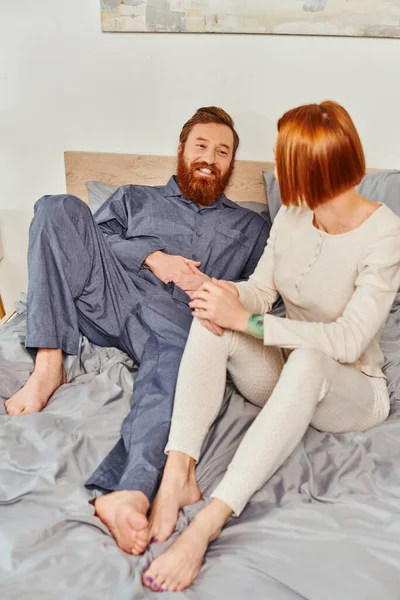 Quality time, day off without kids, redhead husband and wife, bearded man and woman holding hands of each other, cheerful parents alone at home, modern lifestyle, relationship — Stock Photo