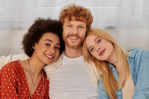 Modern family, polygamy concept, freedom in relationship, cultural diversity, portrait of redhead man and multicultural women looking at camera, polyamorous lifestyle, non traditional lovers — Stock Photo