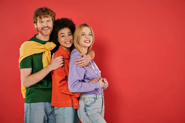 Polyamorous concept, three interracial lovers hugging each other background, cultural diversity, polygamy, happy multiethnic people looking at camera, open relationship — Stock Photo