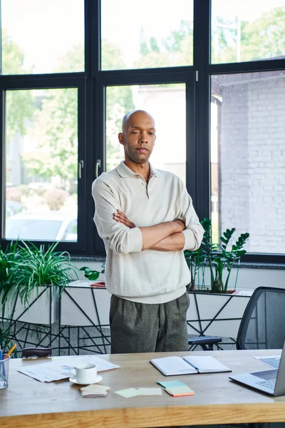 Professional headshots, african american businessman with eye syndrome looking at camera and standing with folded arms, myasthenia gravis, dark skinned and bold office worker — Stock Photo