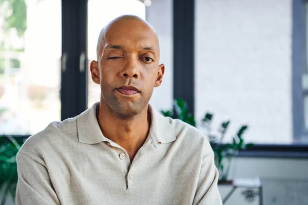 Professional headshots, bold dark skinned man with myasthenia gravis disease looking at camera, african american office worker with ptosis eye syndrome, inclusion and diversity — Stock Photo