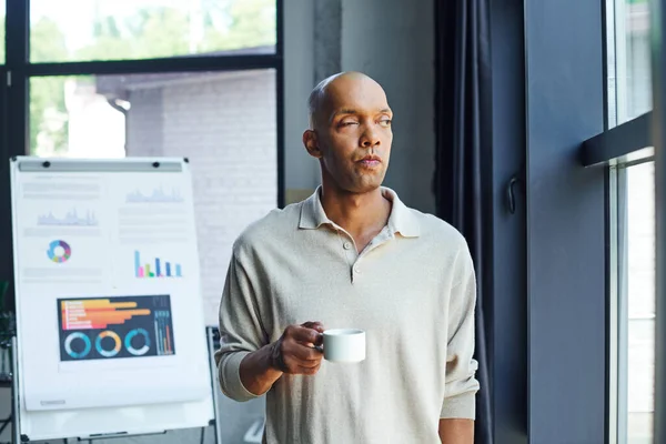 Chronic illness, inclusion, african american man with myasthenia gravis disease holding cup of coffee, pensive and dark skinned office worker in casual attire standing near window, infographics — Stock Photo
