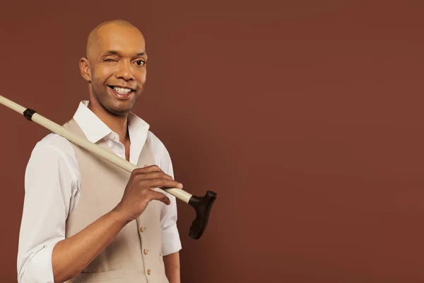 Inclusion, myasthenia gravis syndrome, cheerful african american man holding walking cane, looking at camera, dark skinned, positivity, neurological disorder, physical impairment — Stock Photo