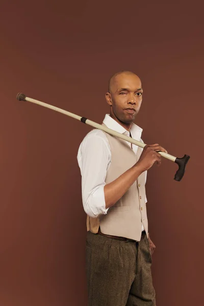 Inclusion, myasthenia gravis syndrome, bold african american man holding walking stick, looking at camera, dark skinned, real people, neurological disorder, physical impairment — Stock Photo