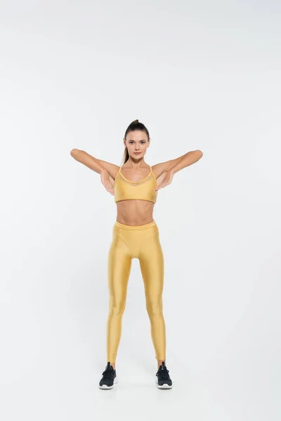 Active lifestyle, aerobics, woman exercising on white background, perseverance and motivation — Stock Photo