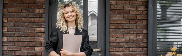 Blonde woman standing with folder near new city building, successful real estate agent, banner — Stock Photo