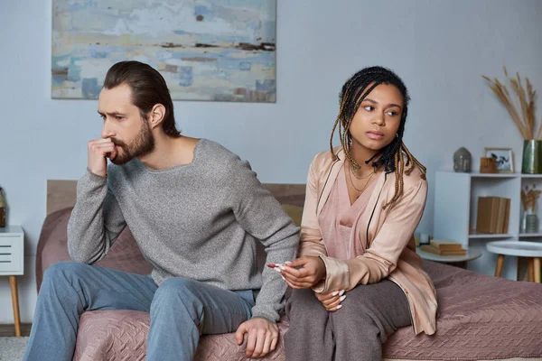 Abortion concept, man and african american woman with pregnancy test, stressed couple, tense — Stock Photo