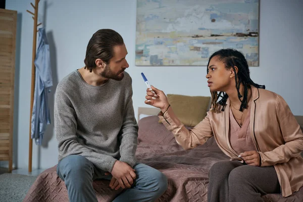 Angry african american woman arguing with man, showing pregnancy test, blame, abortion concept — Stock Photo