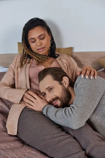 Future parents, bearded man listening belly of pregnant african american wife, bedroom, expectation — Stock Photo