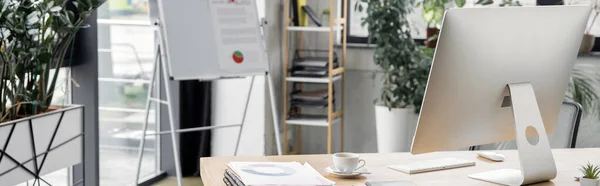 Flip chart, work desk with computer monitor, documents and coffee cup, modern office, banner — Stock Photo