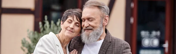 Feliz hombre y mujer abrazos, pareja de ancianos con los ojos cerrados, romance, amor, personas mayores en la fecha, bandera - foto de stock