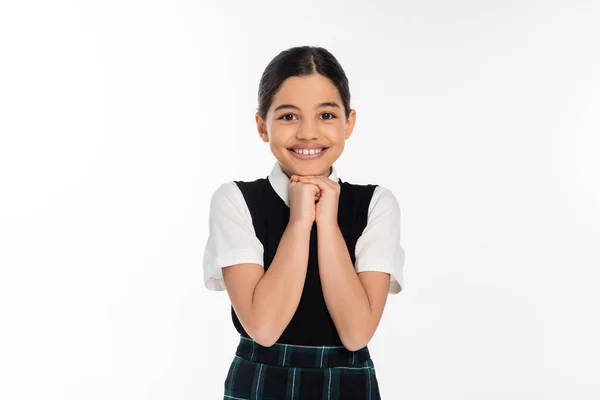 Cheerful schoolgirl in black vest looking at camera isolated on white, school uniform, excitement — Stock Photo