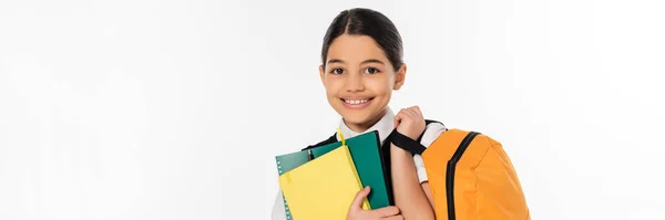 Happy schoolgirl standing with notebooks in and backpack in hands, new school year concept, banner — Stock Photo