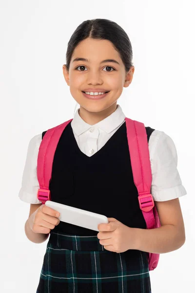 Digital age, schoolgirl holding smartphone isolated on white, student in uniform, banner, horizontal — Stock Photo