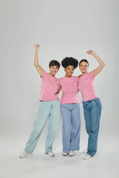 Breast cancer awareness, excited interracial women on grey, different generations, cancer free — Stock Photo