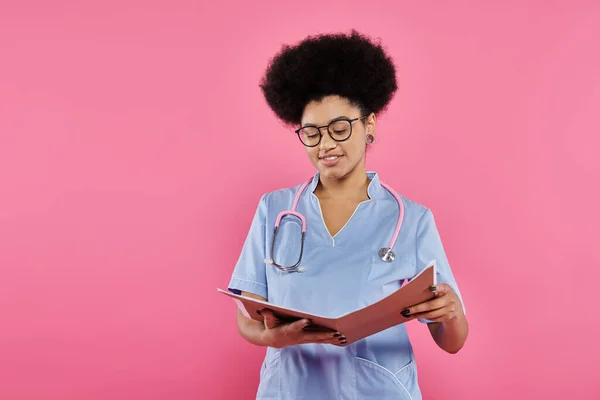 Breast cancer awareness, african american doctor, happy oncologist reading medical record, folder — Stock Photo