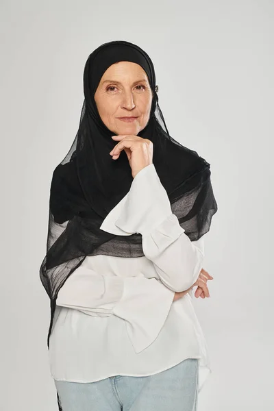 Portrait of woman in hijab looking at camera and posing isolated on grey — Stock Photo