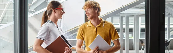 Handsome male coworkers in smart casual smiling and looking at each other, coworking concept — Stock Photo