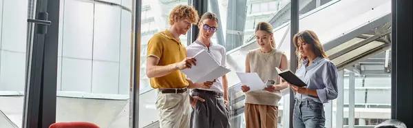 Four colleagues in business casual outfits working on documents, coworking concept, banner — Stock Photo