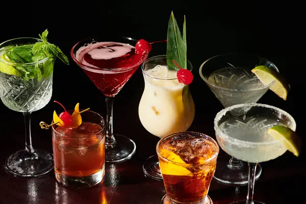 Delicious refreshing set of esthetic cocktails with garnishments on black backdrop, concept — Stock Photo